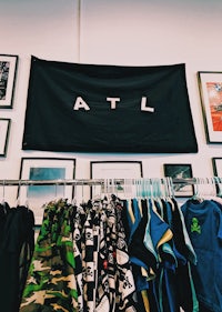 a room full of clothes and a flag with the word atl