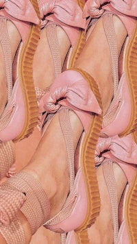 a pair of pink shoes with bows on them