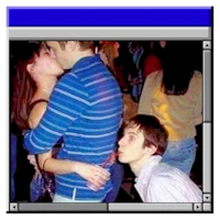 a man kissing a woman in front of a computer screen