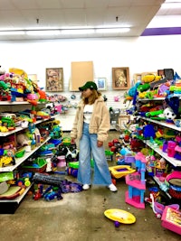 a woman standing in a toy store