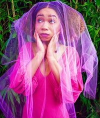 a woman in a pink dress with a veil