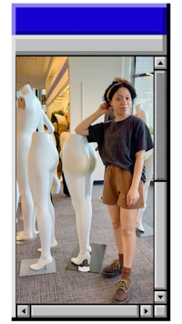 a woman standing in front of mannequins